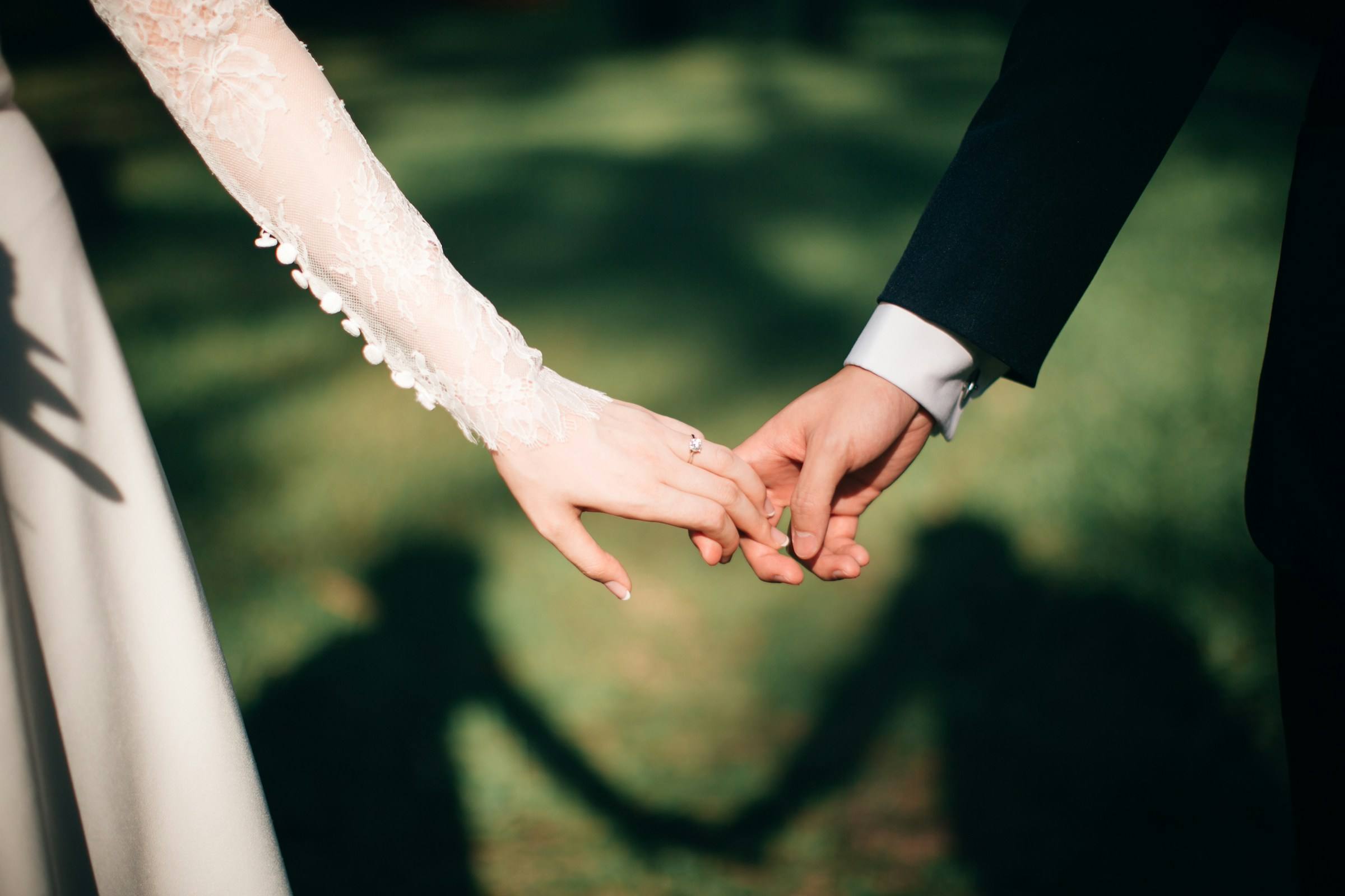 A bride and groom holding hands after their ceremony